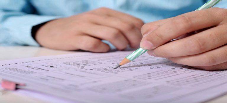 man-filling-omr-sheet-during-uppcs-exam